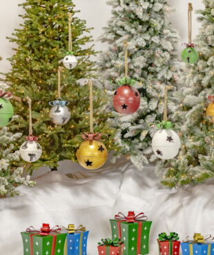 Group of Large Hanging Christmas Bells with Star Designs - and Red Ribbons Hanging from a Rope