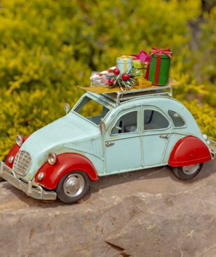 Small red and blue grey vintage buggy model with colorful Christmas gifts on the roof top of the car