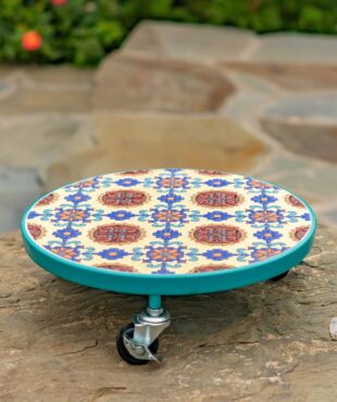 Round light blue plant trolley with mosaic tile design with colors teal, blue, and red